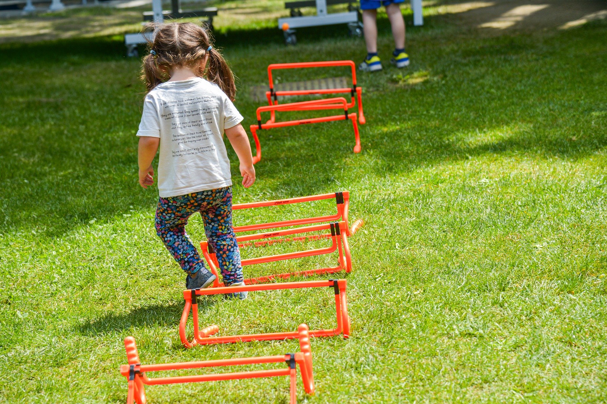 Child in a grass with obstacles